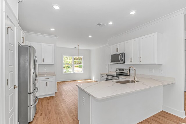 kitchen with visible vents, white cabinetry, light wood-style flooring, and appliances with stainless steel finishes