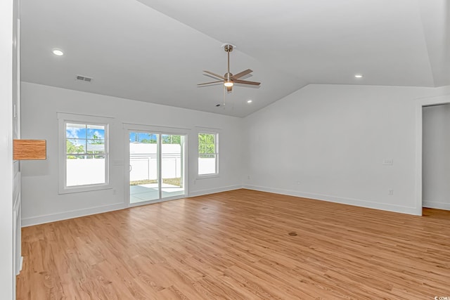 unfurnished living room featuring light wood-type flooring, a healthy amount of sunlight, ceiling fan, and lofted ceiling