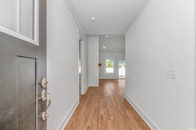 corridor with recessed lighting, light wood-style flooring, and baseboards