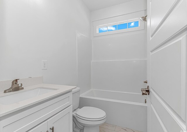 full bathroom featuring toilet, marble finish floor, shower / washtub combination, and vanity