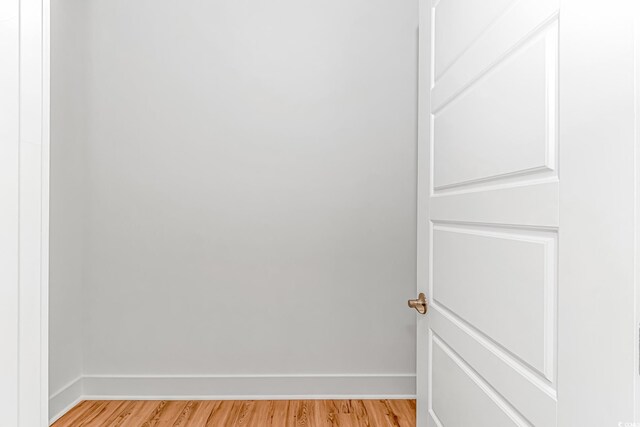 interior space featuring baseboards and light wood finished floors