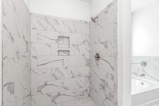 full bath with tiled shower and a garden tub