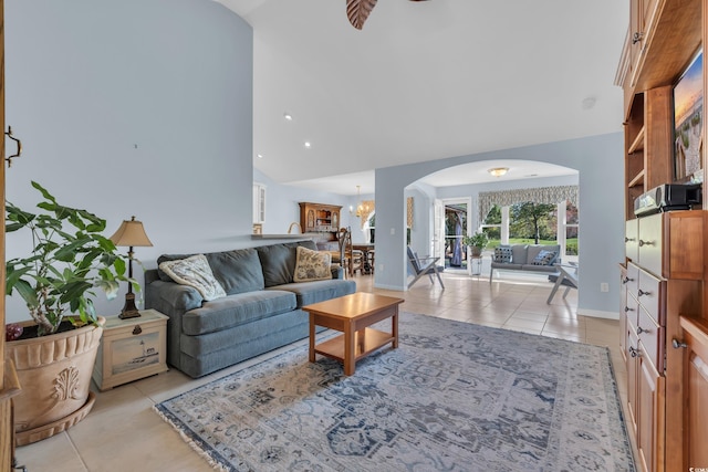 308 Dendy Ct, Myrtle Beach, SC 29579 - living area with arched walkways, light tile patterned flooring, high vaulted ceiling, baseboards, and a chandelier
