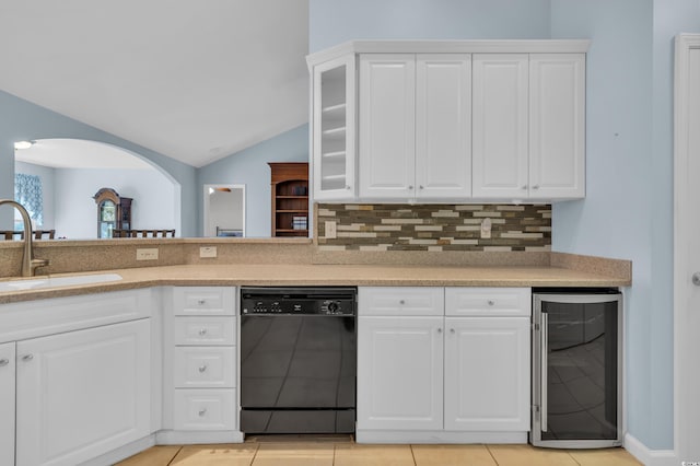308 Dendy Ct, Myrtle Beach, SC 29579 - kitchen with black dishwasher, wine cooler, a sink, vaulted ceiling, and backsplash