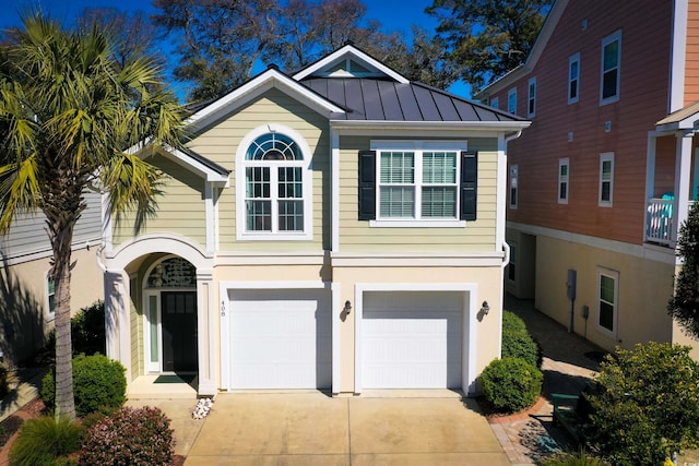 408 7th Ave S, North Myrtle Beach, SC 29582 - view of front of house featuring a garage, driveway, a standing seam roof, and a metal roof
