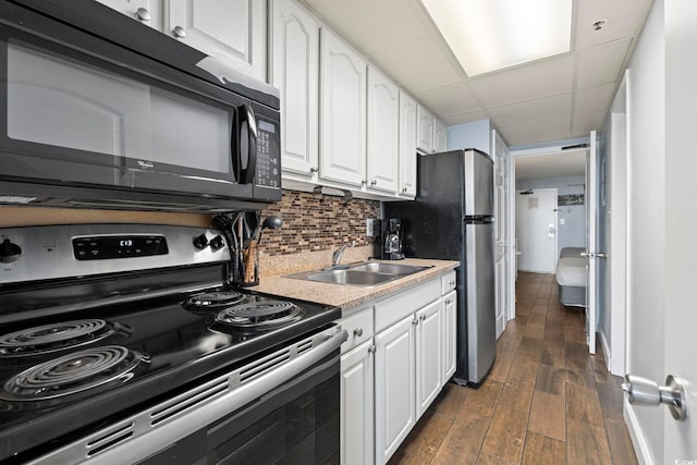 6804 Ocean Blvd N Unit 1529, Myrtle Beach, SC 29572 - kitchen featuring a sink, white cabinets, decorative backsplash, and stainless steel appliances