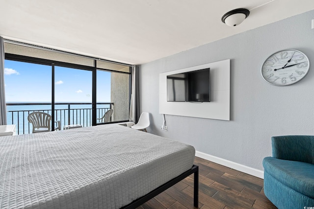 6804 Ocean Blvd N Unit 1529, Myrtle Beach, SC 29572 - bedroom featuring access to exterior, wood finished floors, baseboards, and a wall of windows