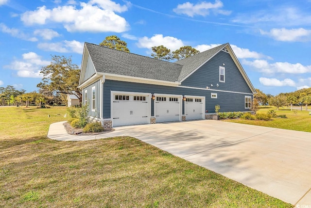 529 Oak Lawn Rd, Georgetown, SC 29440 - view of side of home featuring roof with shingles, a lawn, a garage, and concrete driveway
