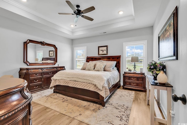 529 Oak Lawn Rd, Georgetown, SC 29440 - bedroom with a tray ceiling, light wood-type flooring, ornamental molding, and multiple windows