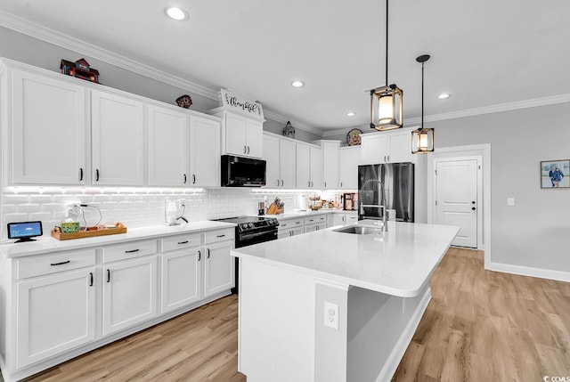 529 Oak Lawn Rd, Georgetown, SC 29440 - kitchen featuring an island with sink, white cabinetry, crown molding, decorative backsplash, and black appliances