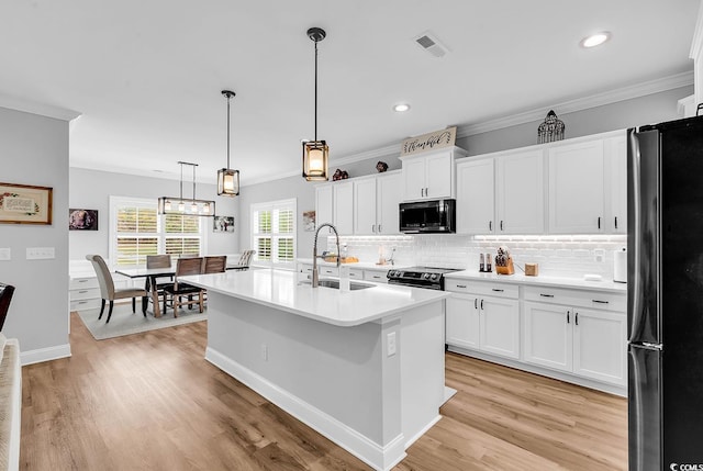 529 Oak Lawn Rd, Georgetown, SC 29440 - kitchen featuring a sink, visible vents, freestanding refrigerator, and crown molding
