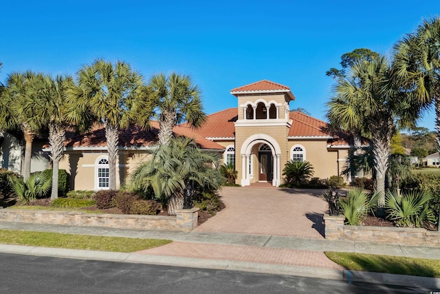 7268 Seville Dr, Myrtle Beach, SC 29572 - mediterranean / spanish home featuring a tile roof, stucco siding, and decorative driveway