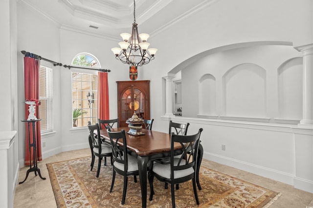 7268 Seville Dr, Myrtle Beach, SC 29572 - dining room with a raised ceiling, healthy amount of natural light, a chandelier, crown molding, and decorative columns