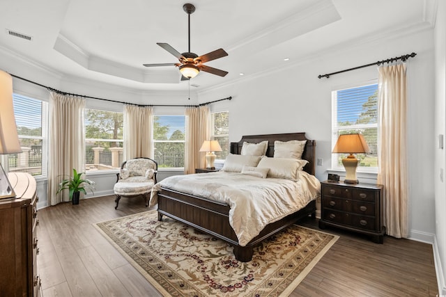 7268 Seville Dr, Myrtle Beach, SC 29572 - bedroom with a tray ceiling, ornamental molding, wood finished floors, baseboards, and a ceiling fan