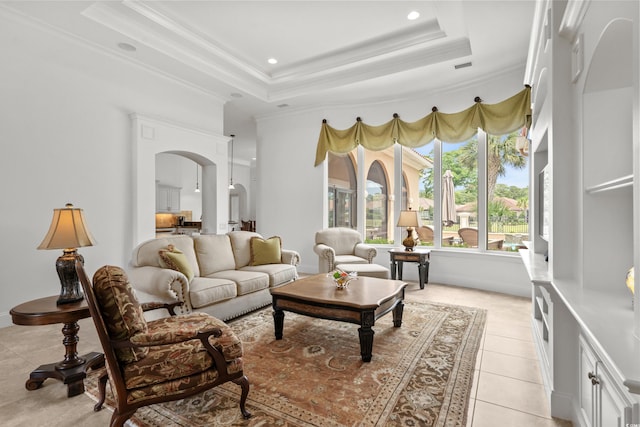 7268 Seville Dr, Myrtle Beach, SC 29572 - living room with arched walkways, light tile patterned flooring, a tray ceiling, ornamental molding, and recessed lighting