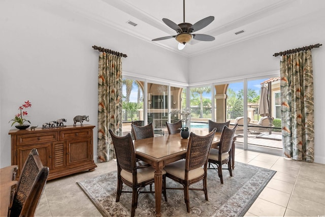 7268 Seville Dr, Myrtle Beach, SC 29572 - dining area featuring a ceiling fan, plenty of natural light, light tile patterned floors, crown molding, and a towering ceiling