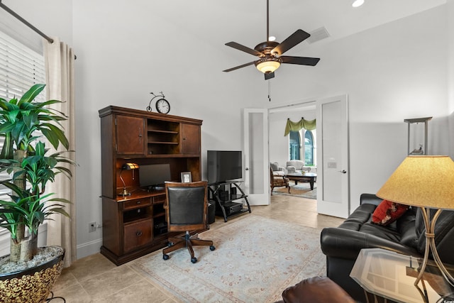 7268 Seville Dr, Myrtle Beach, SC 29572 - home office featuring a towering ceiling, a ceiling fan, and light tile patterned flooring