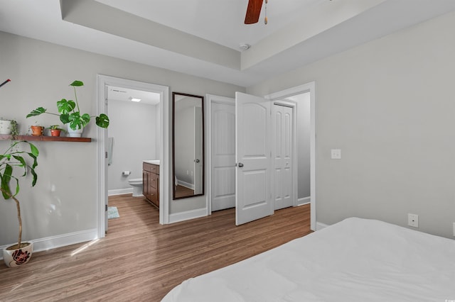 1524 Stilley Cir, Conway, SC 29526 - bedroom with wood finished floors, baseboards, ensuite bathroom, and a tray ceiling