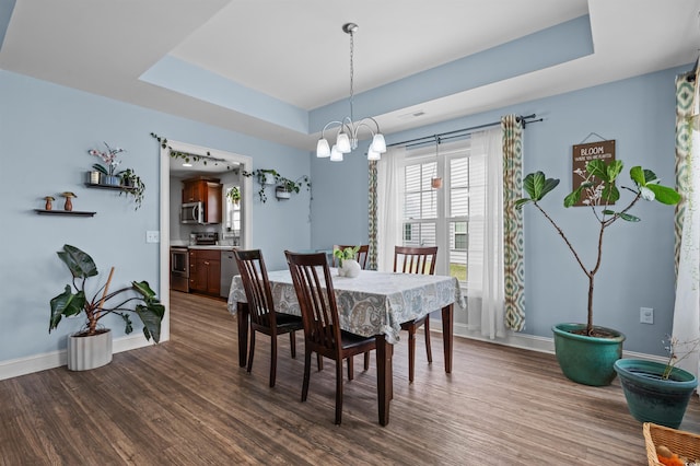 1524 Stilley Cir, Conway, SC 29526 - dining area with a tray ceiling, dark wood finished floors, baseboards, and a chandelier