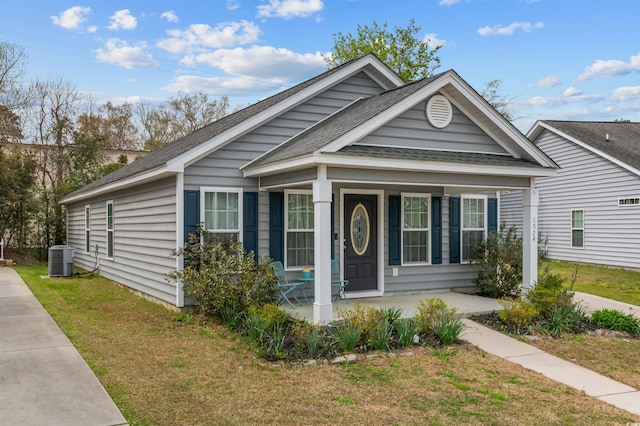 1524 Stilley Cir, Conway, SC 29526 - view of front of home featuring covered porch, roof with shingles, a front yard, and central AC