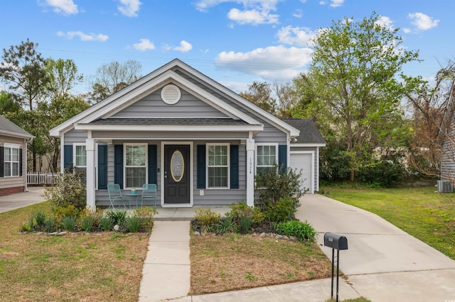 1524 Stilley Cir, Conway, SC 29526 - view of front of home with covered porch, a shingled roof, a front yard, concrete driveway, and a garage
