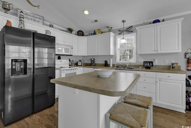 6001-1312 S Kings Hwy, Myrtle Beach, SC 29575 - kitchen with lofted ceiling, white appliances, visible vents, a sink, and white cabinetry