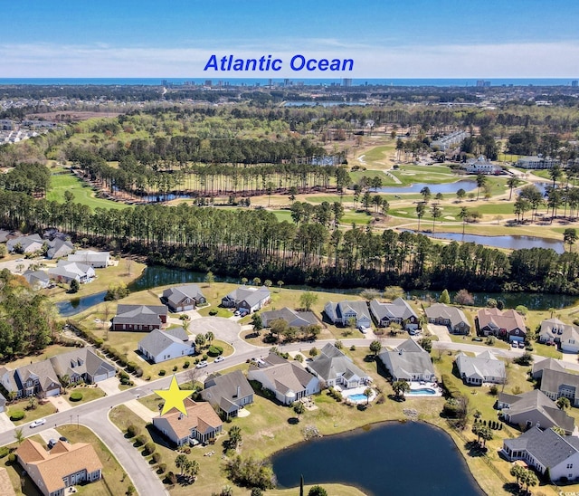 aerial view with a residential view, a water view, and view of golf course