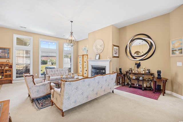 living area featuring a fireplace, visible vents, baseboards, and light carpet