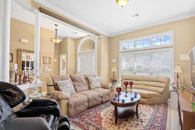 living area with visible vents, ornate columns, and crown molding