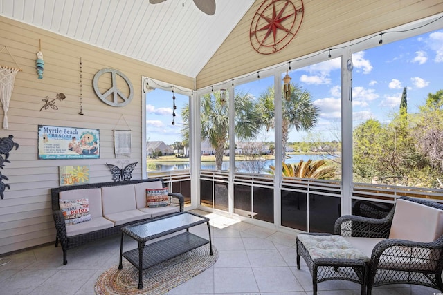 sunroom featuring a ceiling fan, a water view, and an outdoor living space