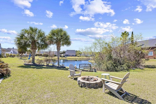 view of yard with an outdoor fire pit and a water view