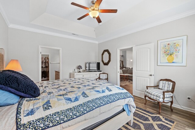 361 Rycola Cir, Myrtle Beach, SC 29575 - bedroom featuring wood finished floors, a tray ceiling, a spacious closet, baseboards, and crown molding