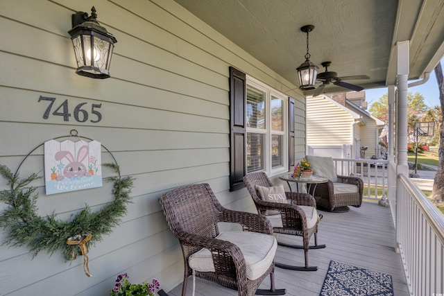 wooden deck with covered porch and a ceiling fan
