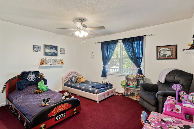 carpeted bedroom with a textured ceiling, a ceiling fan, and baseboards