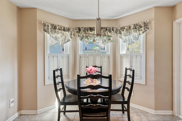 dining room featuring a chandelier, baseboards, light tile patterned floors, and a textured ceiling