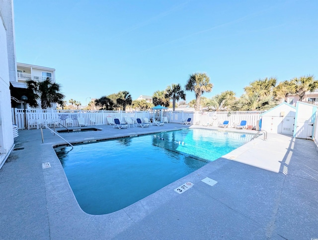 pool featuring a patio and fence