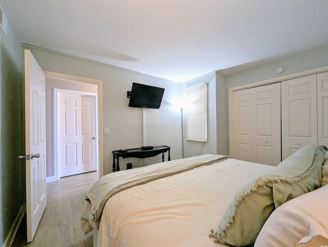 bedroom with a closet and light wood-style flooring