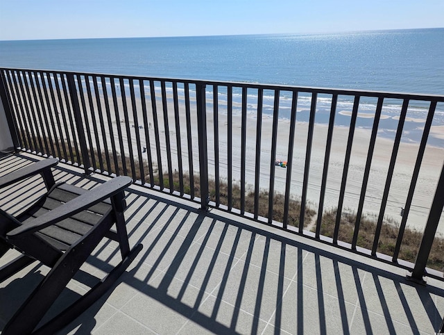 balcony with a water view and a beach view