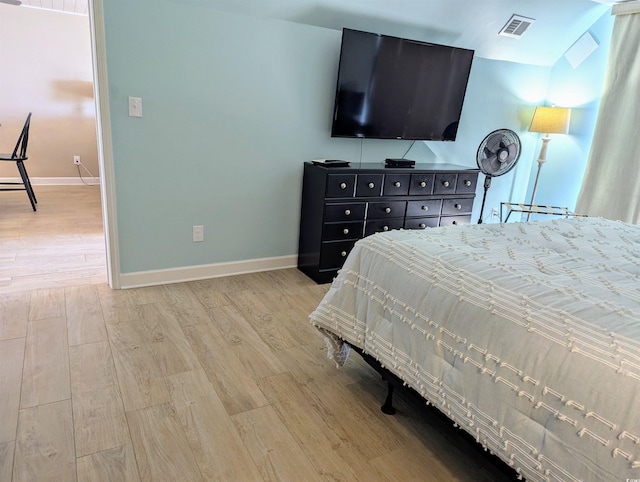 bedroom with light wood-type flooring, baseboards, and visible vents