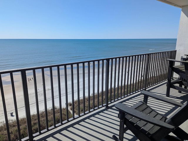 balcony with a water view and a beach view