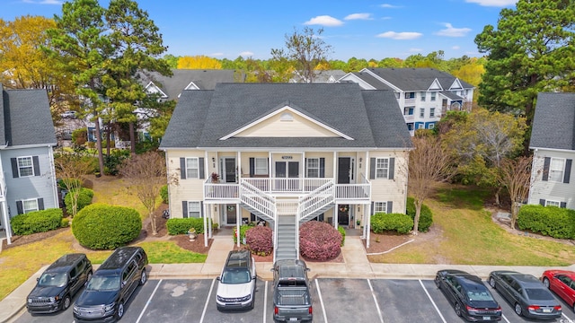 5022 Belleglen Ct Unit 202, Myrtle Beach, SC 29579 - view of front of house with a porch, stairway, uncovered parking, and roof with shingles