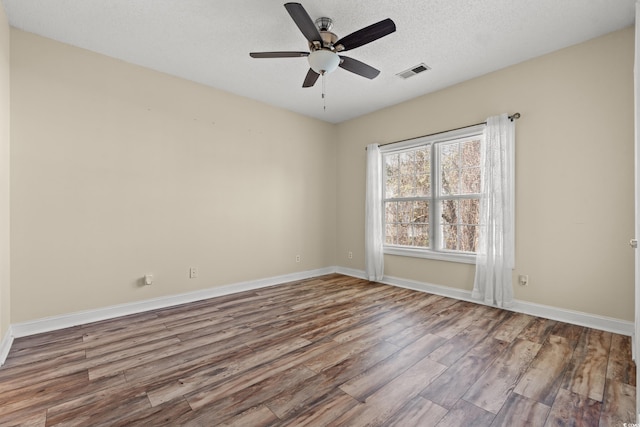5022 Belleglen Ct Unit 202, Myrtle Beach, SC 29579 - spare room with wood finished floors, ceiling fan, baseboards, and a textured ceiling