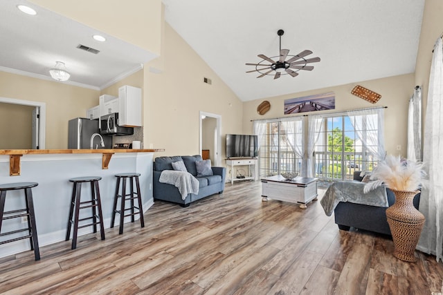 5022 Belleglen Ct Unit 202, Myrtle Beach, SC 29579 - living area featuring wood finished floors, ceiling fan, high vaulted ceiling, and ornamental molding