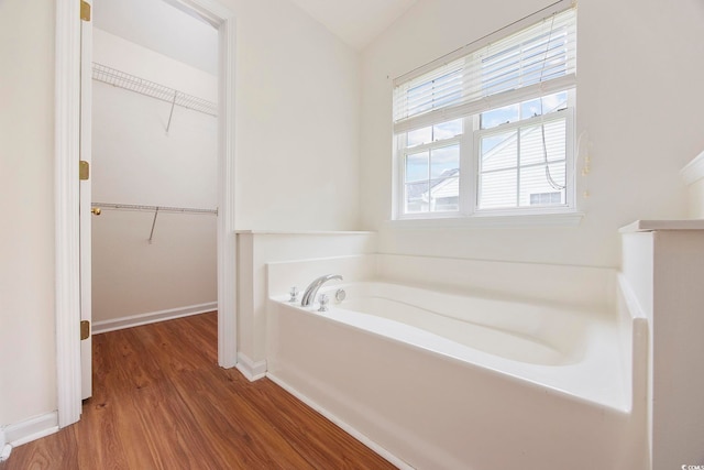 363 Junco Cir, Longs, SC 29568 - bathroom with a garden tub, wood finished floors, baseboards, and a spacious closet