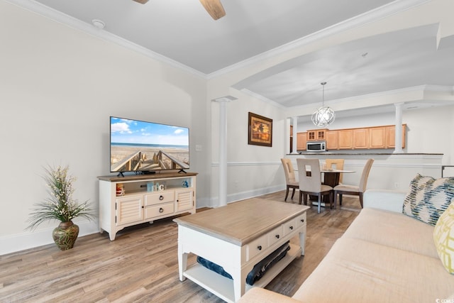 2180 Waterview Dr Unit 1024, North Myrtle Beach, SC 29582 - living room featuring arched walkways, crown molding, baseboards, and light wood-type flooring
