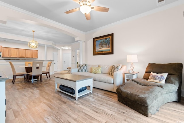 2180 Waterview Dr Unit 1024, North Myrtle Beach, SC 29582 - living room featuring crown molding, a ceiling fan, light wood-type flooring, arched walkways, and ornate columns