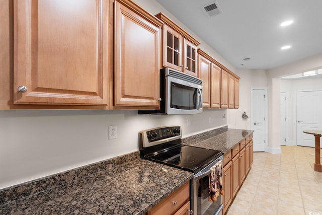 2180 Waterview Dr Unit 1024, North Myrtle Beach, SC 29582 - kitchen with recessed lighting, stainless steel appliances, dark stone countertops, visible vents, and glass insert cabinets