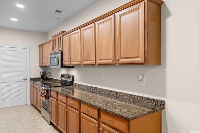 2180 Waterview Dr Unit 1024, North Myrtle Beach, SC 29582 - kitchen with recessed lighting, dark stone counters, visible vents, appliances with stainless steel finishes, and glass insert cabinets