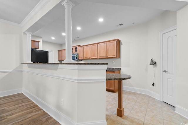 2180 Waterview Dr Unit 1024, North Myrtle Beach, SC 29582 - kitchen featuring decorative columns, stainless steel microwave, baseboards, and visible vents