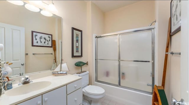full bathroom with vanity, toilet, enclosed tub / shower combo, and tile patterned flooring